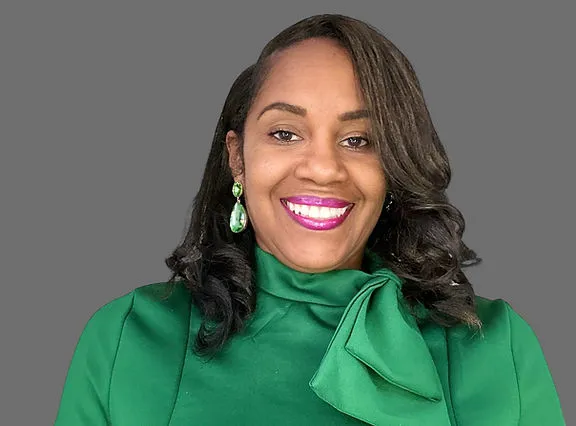 Omesa Ingram smiling in a green blouse